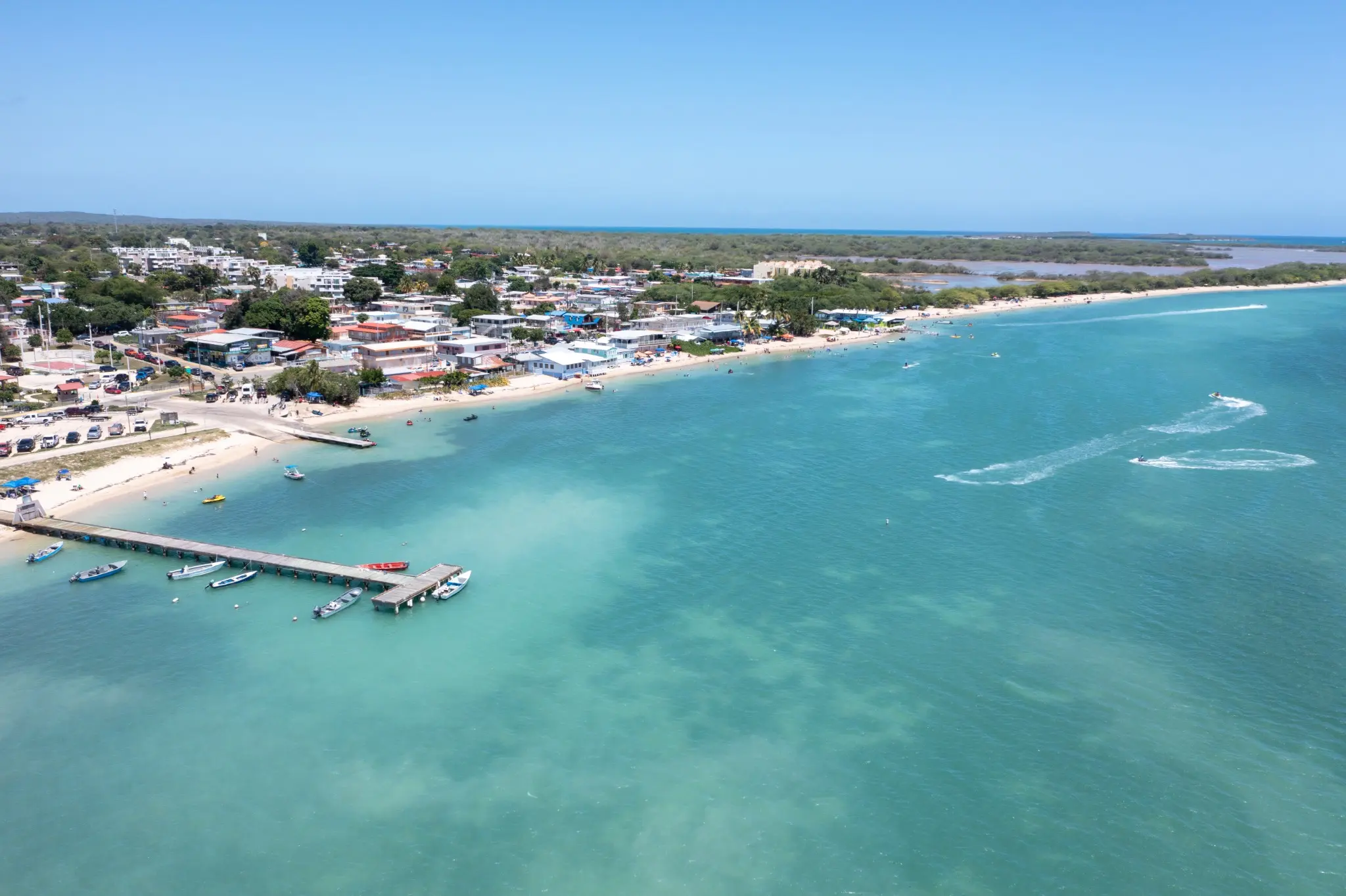 Aerial view of Playa El Combate with its waterfront, piers and boats